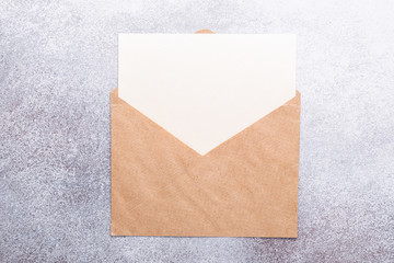Fototapeta premium Blank paper with envelope on grey background