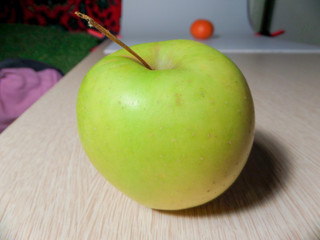 Juicy green apple on a wooden table