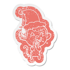 crazy cartoon distressed sticker of a monkey wearing santa hat