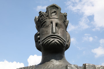 Head Shot Of Bronze Statue Against Blue Sky 