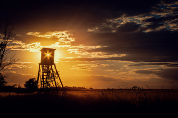 Dark Sunset Landscape with Sun in Hunting Tower