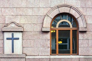 Fototapeta na wymiar Window with arch and cross.