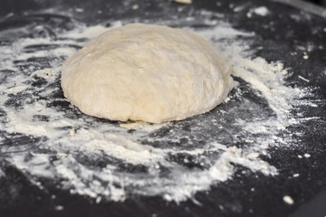 dough on a black table, homemade food