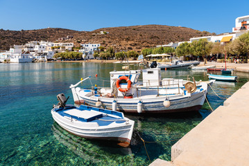 Fototapeta na wymiar Fishing boats moored in the port of the picturesque village of Faros in Sifnos. Greece