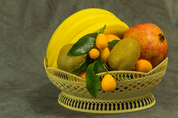 Fruits, pomegranates, bananas, tangerines and kiwi.