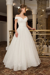 Naklejka premium Portrait of a beautiful bride woman in elegant white wedding dress. Luxurious apartments. 