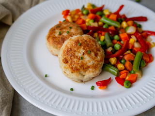 Chicken cutlets with steamed Mix vegetables, Chicken meat balls on white plate. Heathy lunch, diet food. Selective focus, close up.
