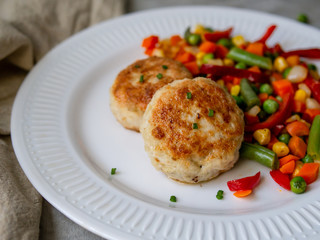 Chicken cutlets with steamed Mix vegetables, Chicken meat balls on white plate. Heathy lunch, diet food. Selective focus, close up.
