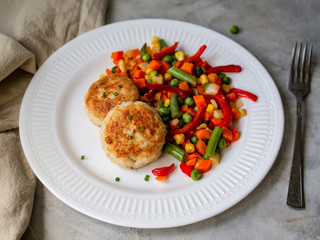 Chicken cutlets with steamed Mix vegetables, Chicken meat balls on white plate. Heathy lunch, diet food. Selective focus, close up.