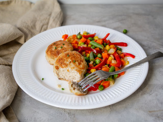 Chicken cutlets with steamed Mix vegetables, Chicken meat balls on white plate. Heathy lunch, diet food. Selective focus, close up.