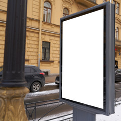 Vertical city billboard with white field MOCKUP. In the city center in the afternoon with snow in the winter outdoor advertising ad