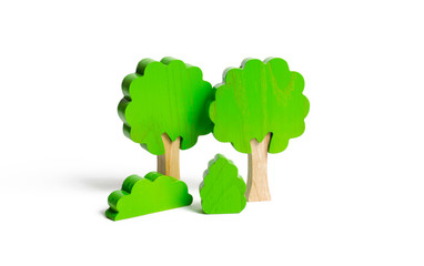 Wooden figures of trees and bushes on an isolated background. The concept of forests and nature. Preserving the environment from human influence. Illegal deforestation. Restoration of natural habitats