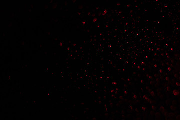 Colored drops on a glass at night