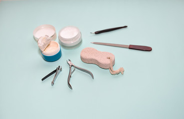 simple home pedicure set minimalism on an isolated blue background and cream