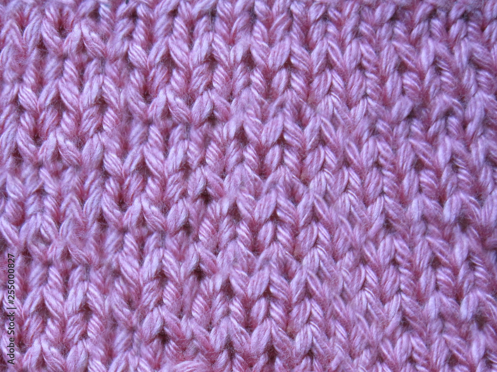 Wall mural Pink knitted sweater handmade with a grid pattern