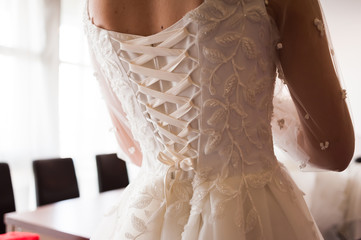 Morning of the bride when she wears a beautiful dress  woman getting ready before wedding ceremony 