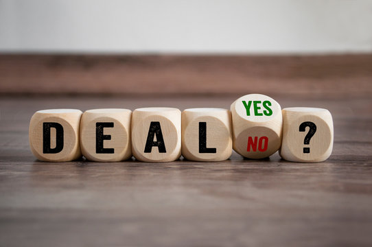 Cubes dice with deal yes or no on wooden background