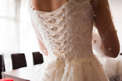 Morning of the bride when she wears a beautiful dress  woman getting ready before wedding ceremony 