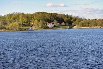 Fototapeta na wymiar Historic pedestrian ferry across the river Daugava near Jaunjelgava, Latvia - image