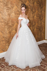 Fototapeta premium Morning of the bride when she wears a beautiful dress woman getting ready before wedding ceremony 
