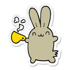 sticker of a cute cartoon rabbit drinking coffee