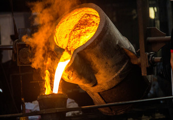 metal casting process with red high temperature fire in metal part factory