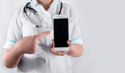 A doctor woman pointing at a smartphone. 