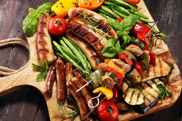 Assorted delicious grilled meat with vegetable on a barbecue. Grilled pork shish or kebab on skewers with vegetables . Food background shashlik