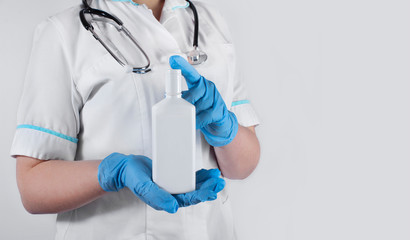 A doctor woman with stethoscope holding a bottle with some mixture. Medical and scientific concept.