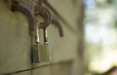 close up shallow focus old padlock on wooden door