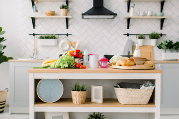 Obraz na płótnie Canvas Table background in kitchen and fresh milk, vegetables, fruits and baby food. Modern kitchen interior
