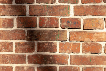 Old brick wall, grunge texture of red stone blocks close-up