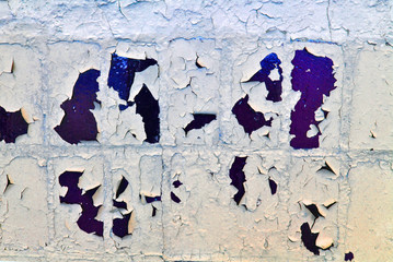 Cracked soft paint on dark blue tiles, grunge horizontal shabby background detail close up