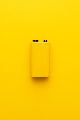 blank nine-volt battery on the yellow background