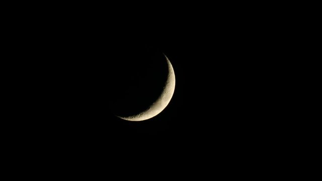 Crescent moon on dark sky at night