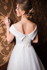 Bride.Young fashion model with perfect skin and make up  brown background  curly hair