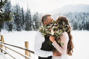 kiss love couples. wedding in winter. boy and girl in the winter forest.