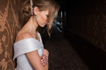Bride.Young fashion model with perfect skin and make up  brown background  curly hair