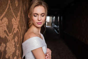 Bride.Young fashion model with perfect skin and make up  brown background  curly hair