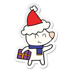 female polar bear with christmas present wearing santa hat