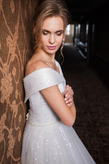 Bride.Young fashion model with perfect skin and make up  brown background  curly hair