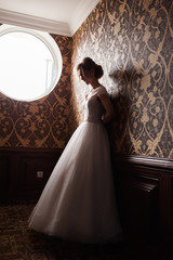 Bride.Young fashion model with perfect skin and make up  brown background  curly hair