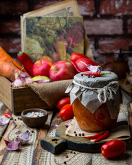 Homemade hot sauce adjika in glass jar 
