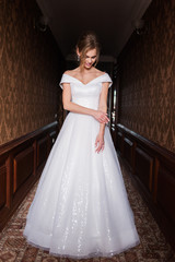 Bride.Young fashion model with perfect skin and make up  brown background  curly hair