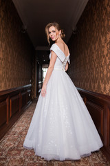 Bride.Young fashion model with perfect skin and make up  brown background  curly hair