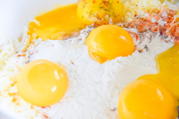 raw yolks lie on white flour cooking spices top view abstraction
