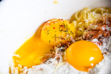 raw yolks lie on white flour cooking spices top view abstraction