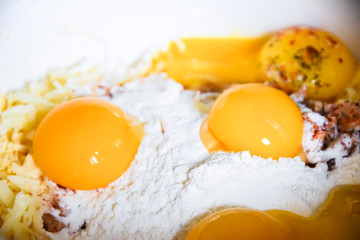 raw yolks lie on white flour cooking spices top view abstraction