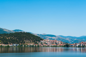 city on the lake, mountains, orange rooftops.