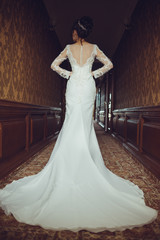 Bride wearing long wedding dress.